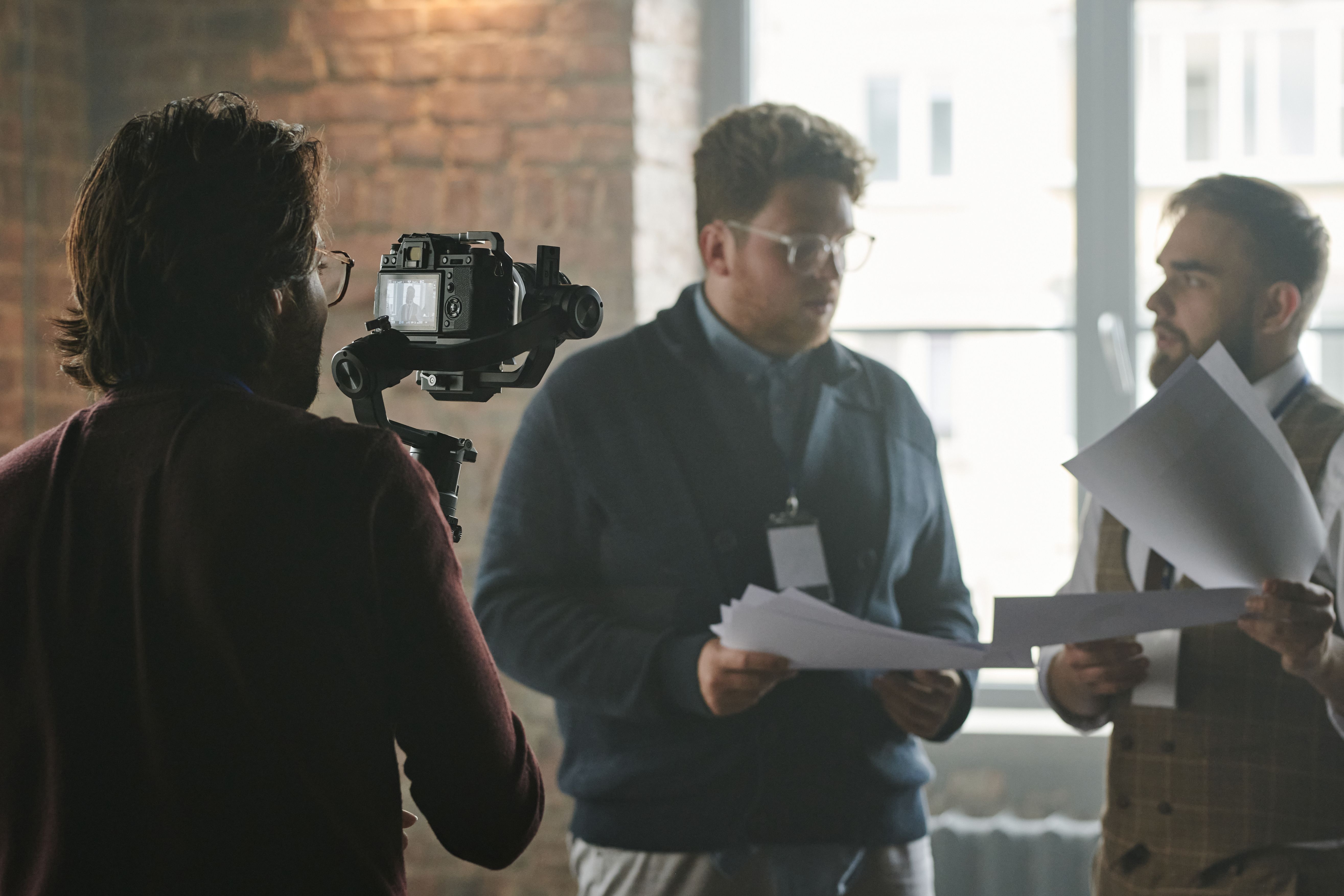 A video production crew filming a corporate scenario.